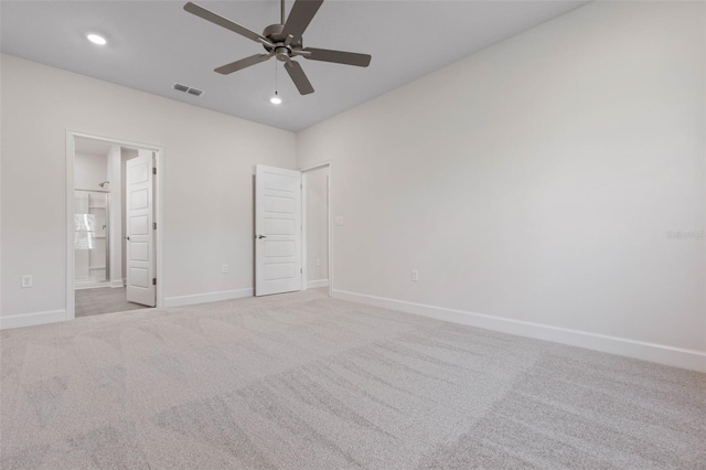 unfurnished bedroom with visible vents, light carpet, ensuite bath, recessed lighting, and baseboards