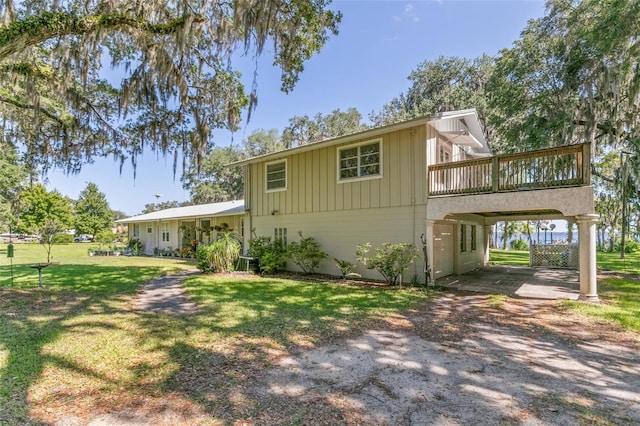 view of front of house featuring a front lawn and a deck