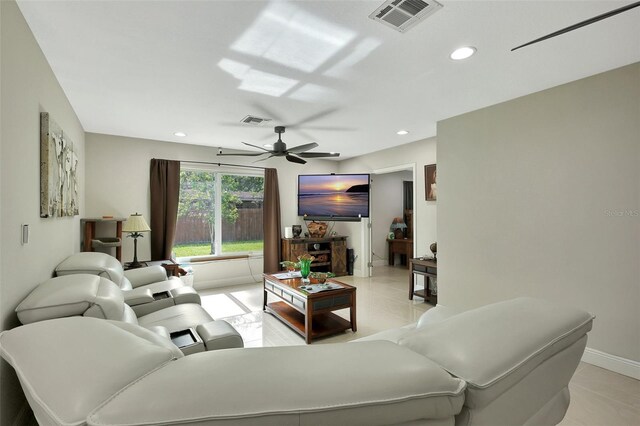 living room with ceiling fan and light tile patterned floors