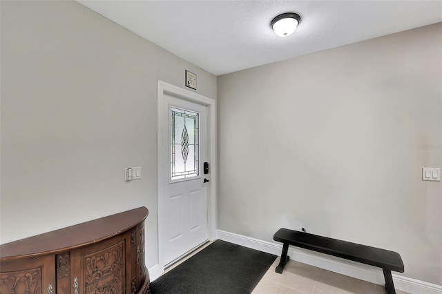 entryway featuring a textured ceiling and light tile patterned floors