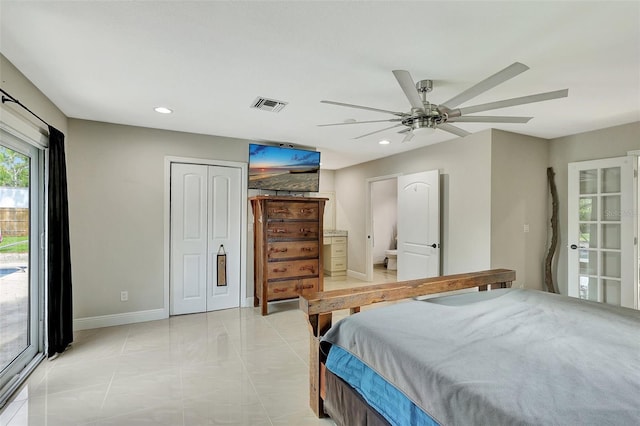 tiled bedroom featuring ceiling fan