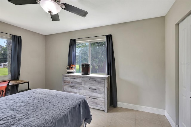 bedroom featuring a closet, ceiling fan, and light tile patterned floors