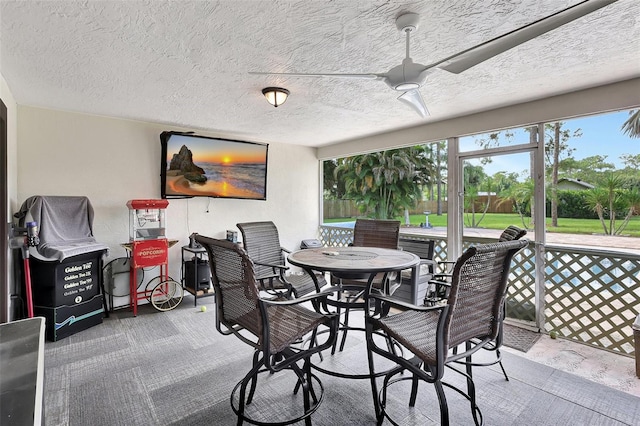 dining area featuring a textured ceiling, carpet flooring, and ceiling fan