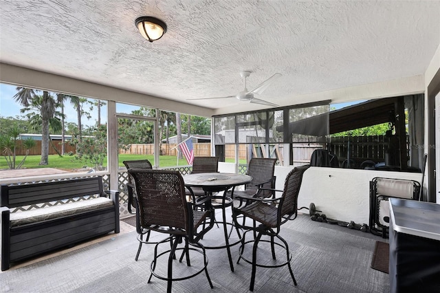 sunroom / solarium featuring ceiling fan