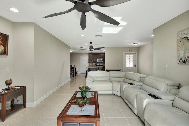 tiled living room with ceiling fan