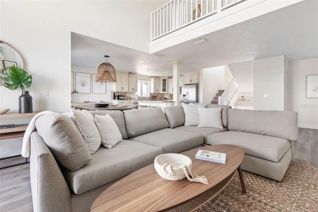 living room featuring sink and light hardwood / wood-style flooring