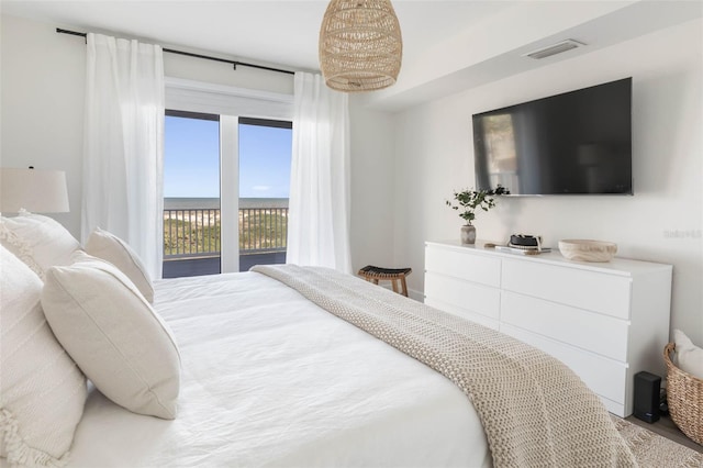 bedroom featuring hardwood / wood-style floors and access to outside