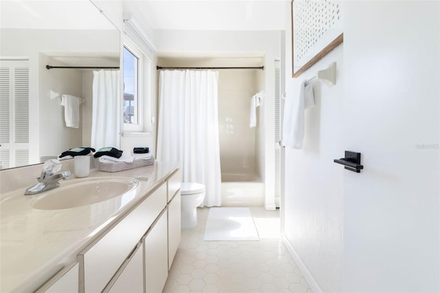 full bathroom featuring a closet, toilet, vanity, a shower stall, and tile patterned flooring