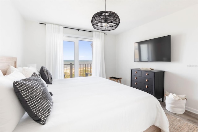 bedroom featuring hardwood / wood-style flooring and access to exterior