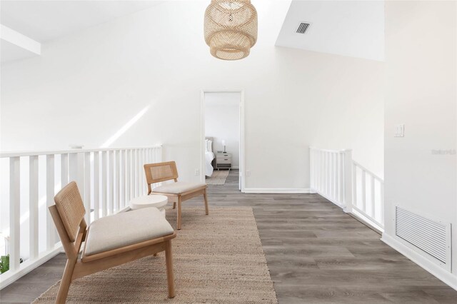 living area with dark wood-type flooring and vaulted ceiling