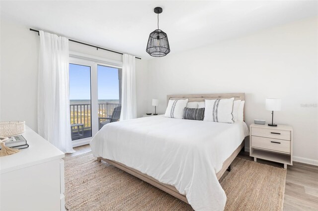 bedroom featuring light wood-type flooring and access to outside