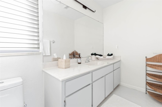 bathroom featuring vanity, toilet, and tile patterned floors