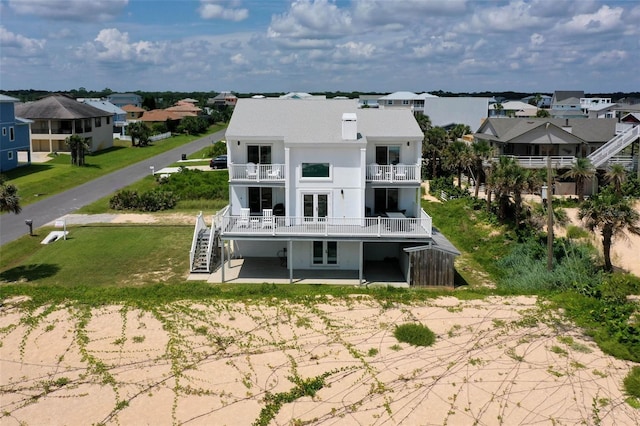 back of property featuring a patio area, a residential view, stairway, and french doors