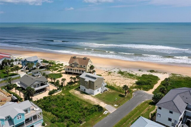 bird's eye view featuring a view of the beach, a water view, and a residential view