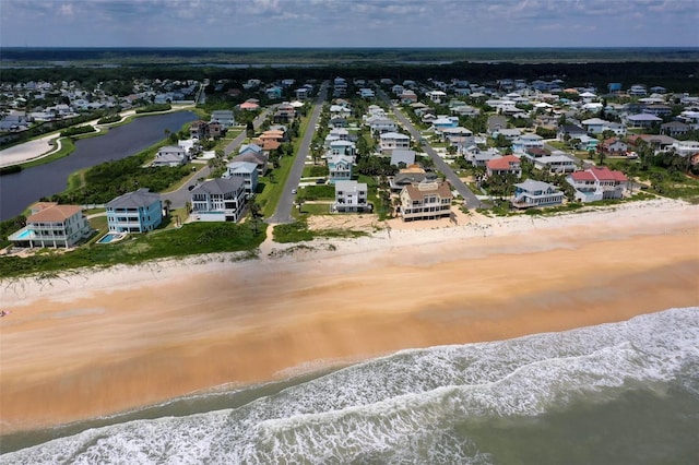 birds eye view of property with a beach view and a water view