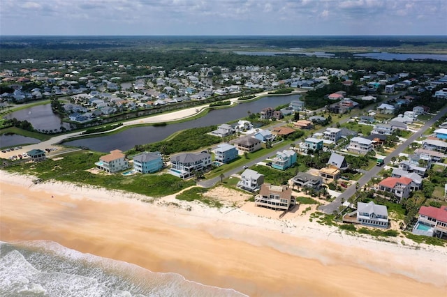 bird's eye view with a beach view, a water view, and a residential view