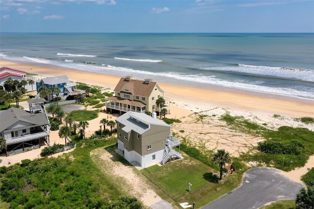 drone / aerial view with a water view and a view of the beach