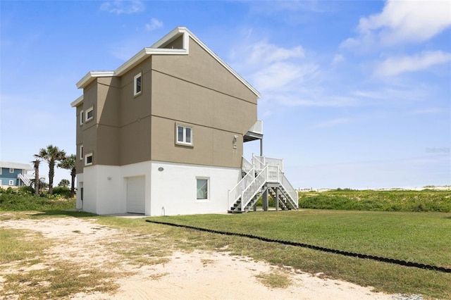 view of side of home with a yard and a garage