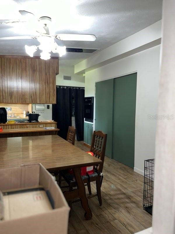 kitchen featuring hardwood / wood-style flooring and black appliances