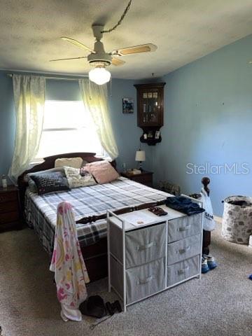 bedroom with ceiling fan and carpet