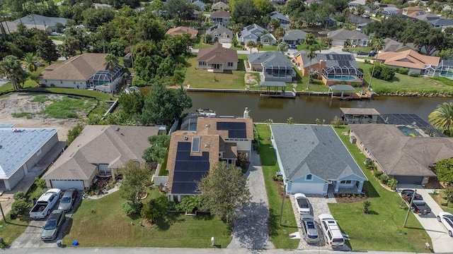 drone / aerial view with a water view and a residential view