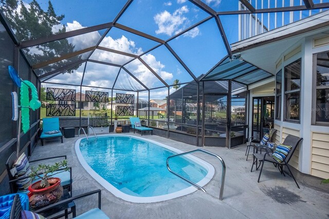 view of pool featuring a lanai and a patio area