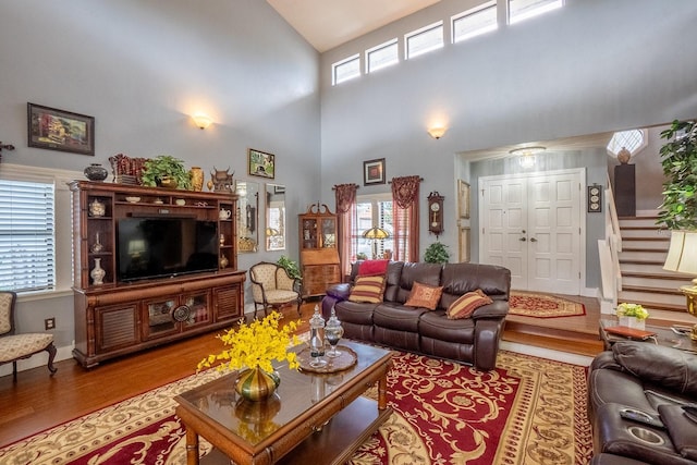 living area with stairway and wood finished floors