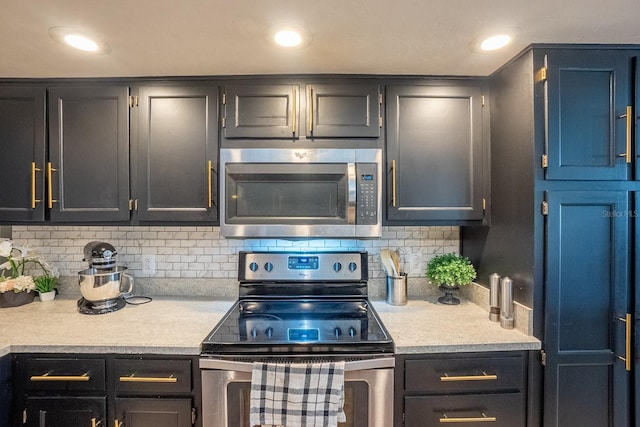 kitchen featuring light countertops, appliances with stainless steel finishes, backsplash, and recessed lighting