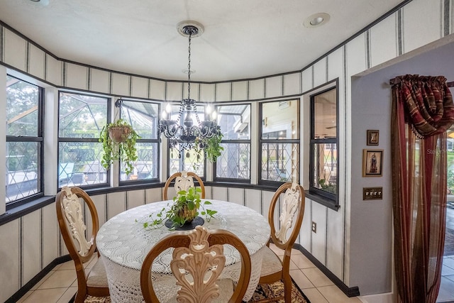 dining room with light tile patterned flooring and an inviting chandelier