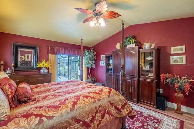 bedroom featuring access to exterior, light wood-style flooring, vaulted ceiling, and a ceiling fan