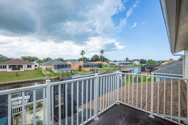 balcony featuring a water view and a residential view