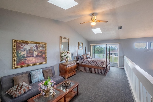 bedroom featuring visible vents, dark carpet, ceiling fan, access to outside, and vaulted ceiling with skylight