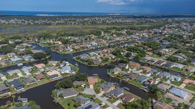 birds eye view of property with a residential view and a water view