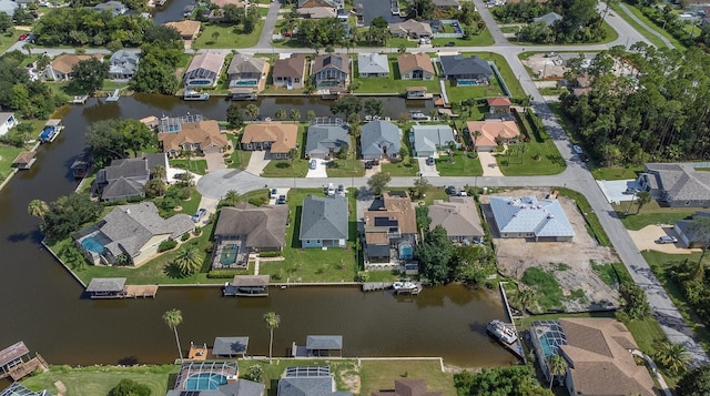 birds eye view of property featuring a residential view and a water view