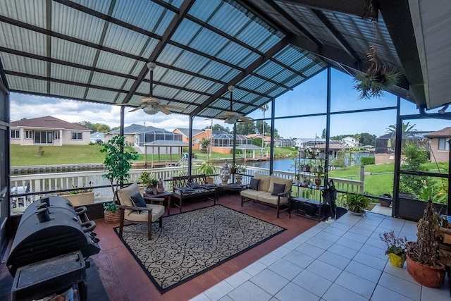 view of patio / terrace with a water view, a residential view, outdoor lounge area, and a ceiling fan