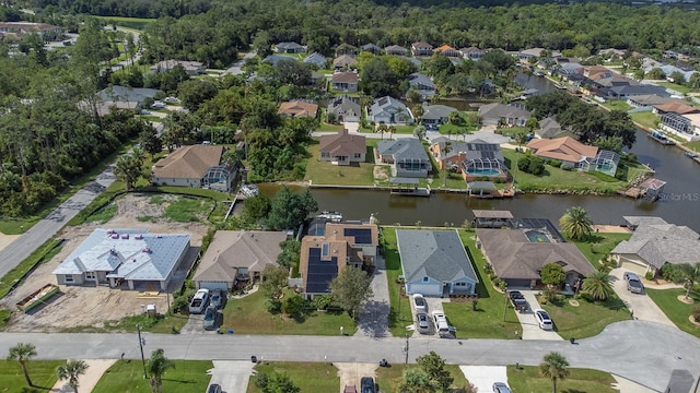 birds eye view of property with a water view and a residential view