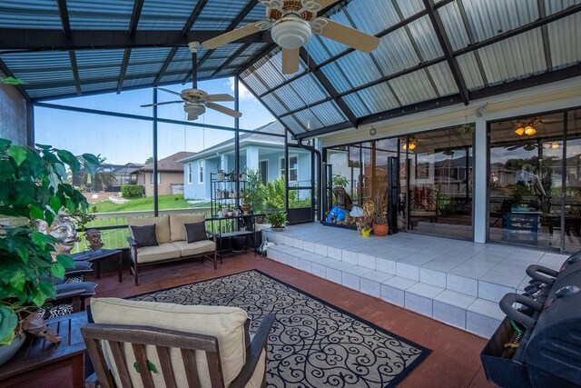 sunroom featuring vaulted ceiling and ceiling fan