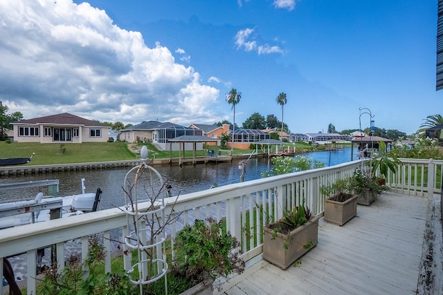 exterior space with a water view, boat lift, a residential view, and a boat dock