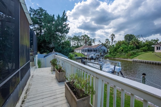 balcony featuring a boat dock and a water view