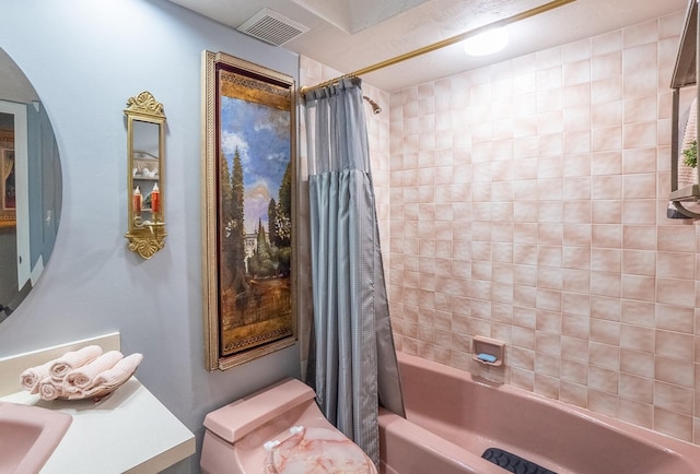 bathroom featuring vanity, shower / bath combination with curtain, and visible vents