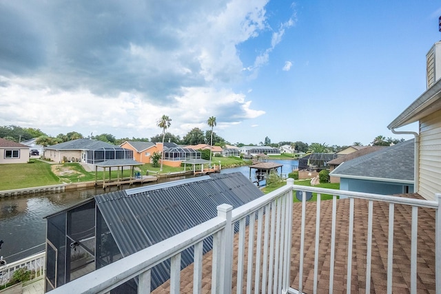 balcony featuring a residential view and a water view