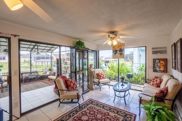 sunroom / solarium featuring a wall unit AC and ceiling fan