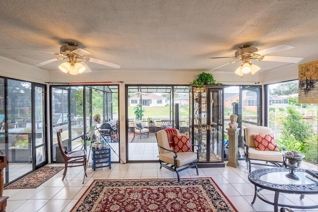 sunroom featuring a ceiling fan and a wealth of natural light