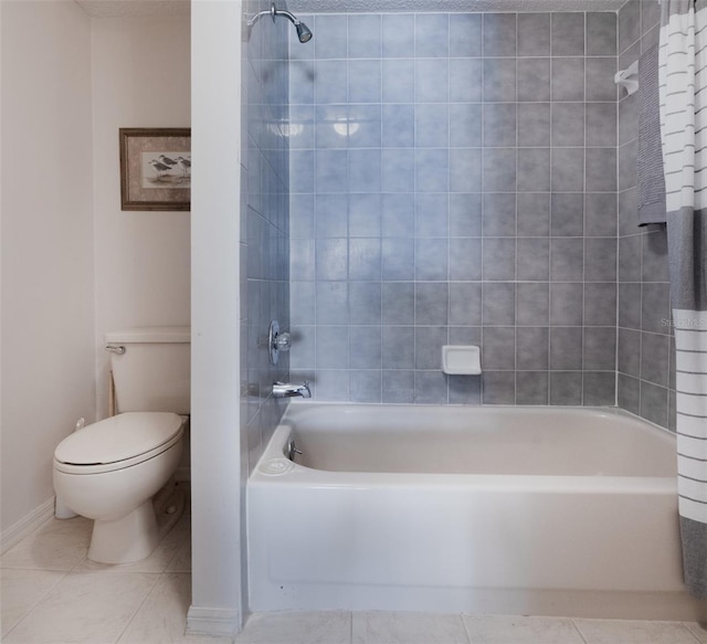 bathroom featuring tile patterned floors, toilet, and tiled shower / bath