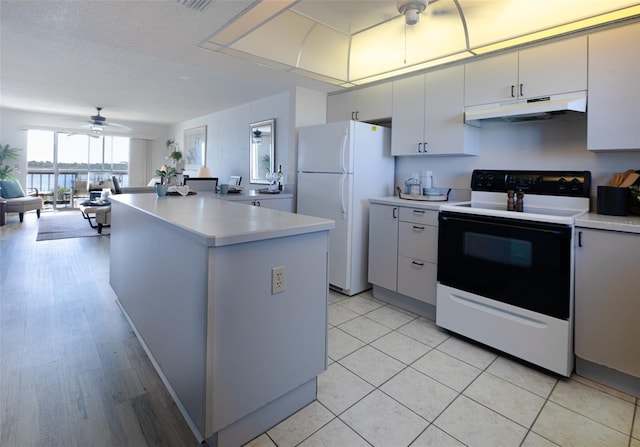 kitchen with light tile patterned floors, white appliances, white cabinetry, and ceiling fan