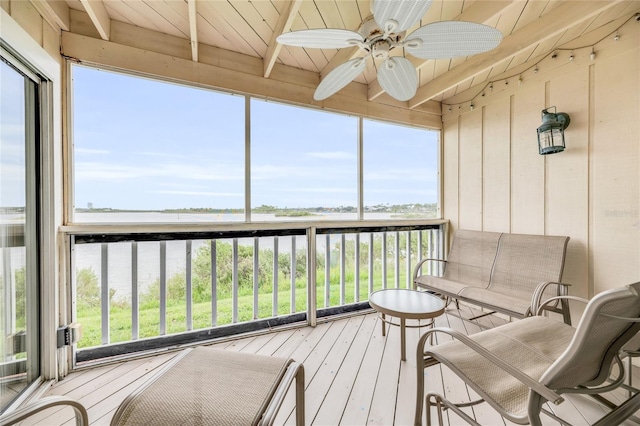 sunroom with beamed ceiling, a water view, ceiling fan, and wood ceiling