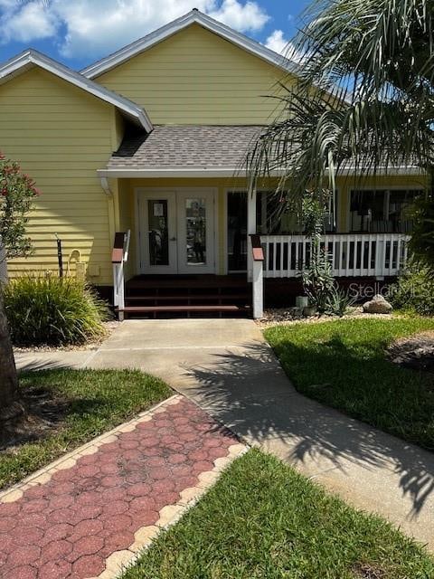 view of front of house featuring covered porch and french doors