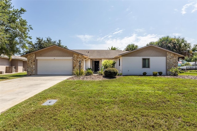 ranch-style home with a garage, stone siding, driveway, and a front yard