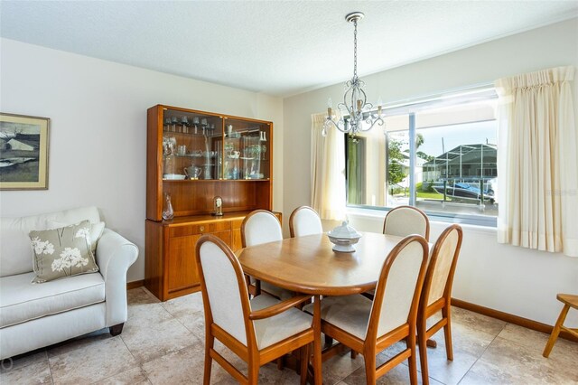 dining space featuring a notable chandelier and light tile patterned floors