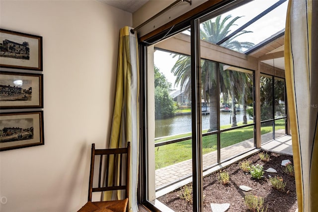 sunroom / solarium with a water view